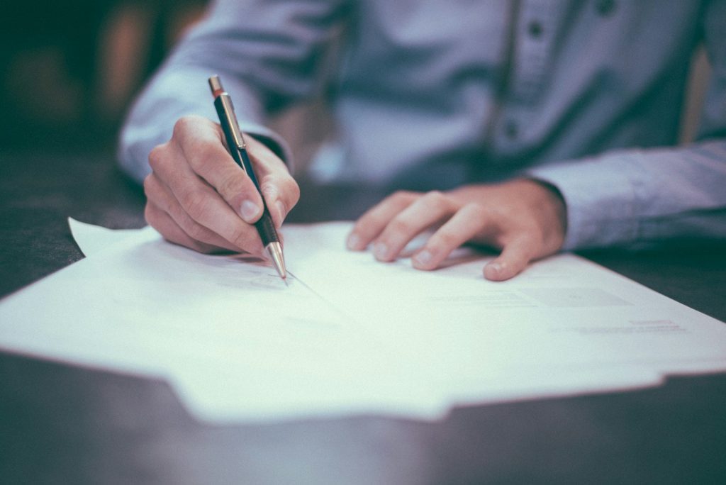 Business owner signing an insurance proposal form
